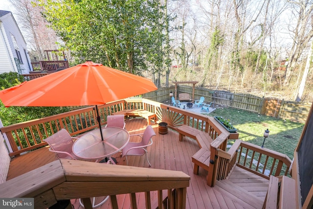 wooden terrace with a yard, outdoor dining space, and a fenced backyard