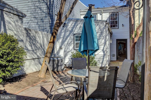 view of patio featuring central AC unit and outdoor dining area