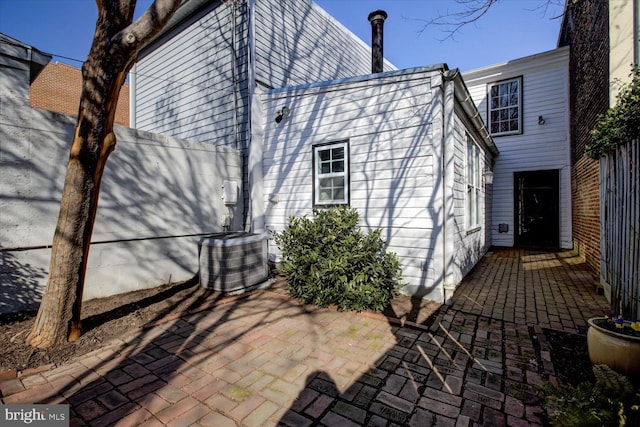 back of property featuring a patio area, central AC, and fence