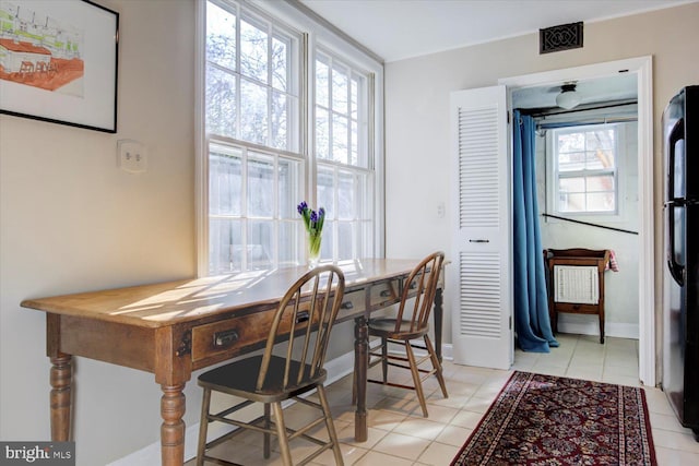 dining area featuring light tile patterned flooring, visible vents, and baseboards