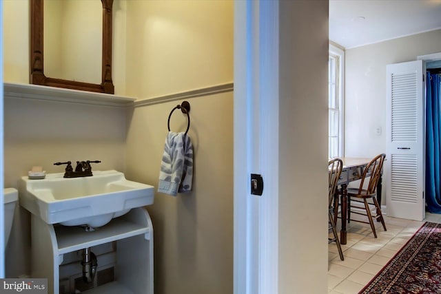 bathroom featuring tile patterned flooring and a sink