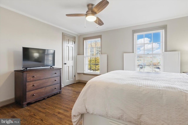 bedroom with multiple windows, dark wood-style floors, and crown molding