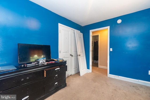 bedroom with a closet, baseboards, and carpet