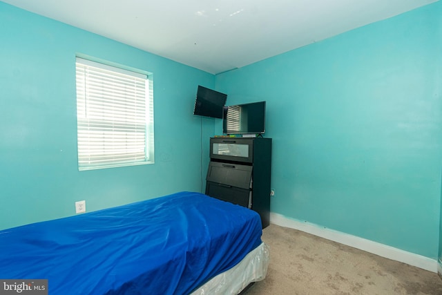 bedroom featuring baseboards and carpet floors