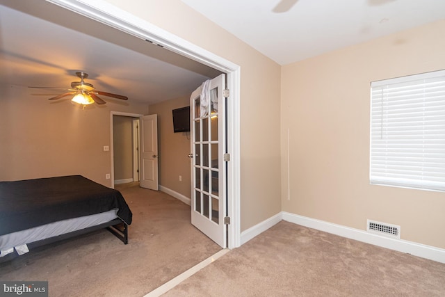 bedroom featuring baseboards, visible vents, carpet floors, and ceiling fan