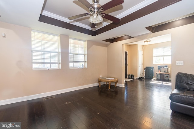 sitting room featuring a tray ceiling, crown molding, wood finished floors, and visible vents