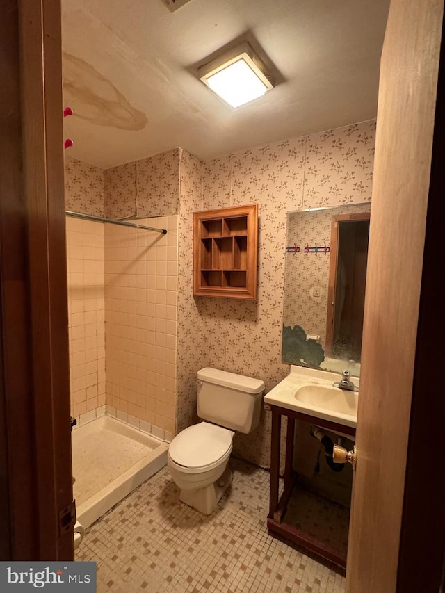 bathroom with tile patterned flooring, a shower stall, toilet, and vanity