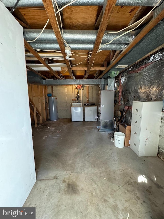 unfinished below grade area with water heater and separate washer and dryer