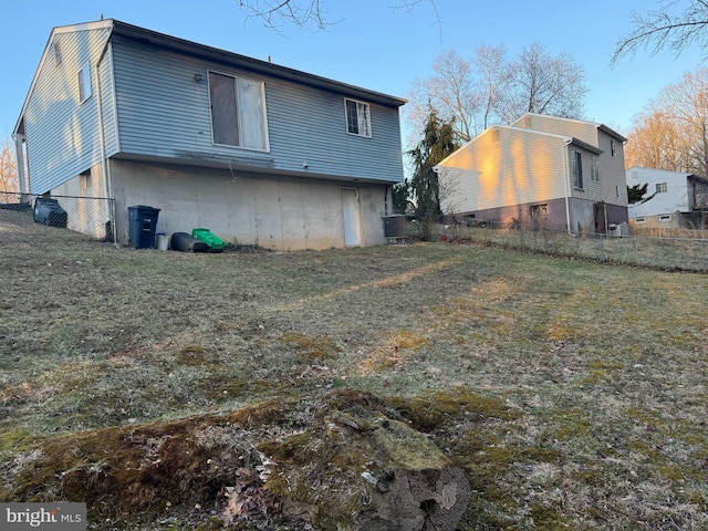 back of house with central air condition unit and fence