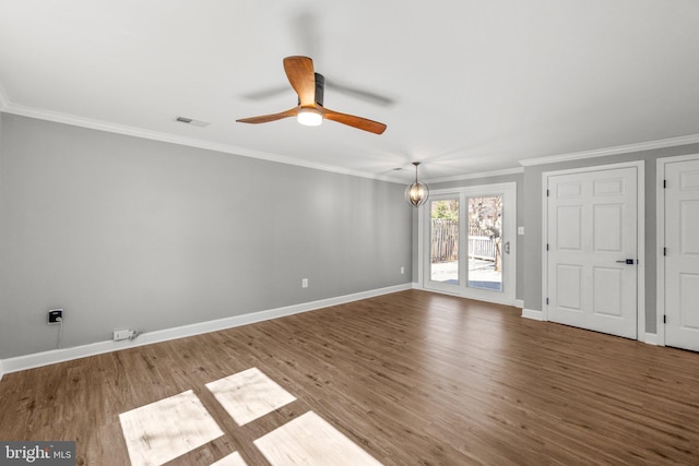 unfurnished living room with visible vents, baseboards, wood finished floors, and ornamental molding