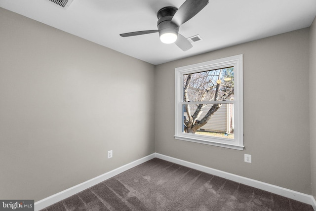 empty room with dark colored carpet, visible vents, baseboards, and ceiling fan