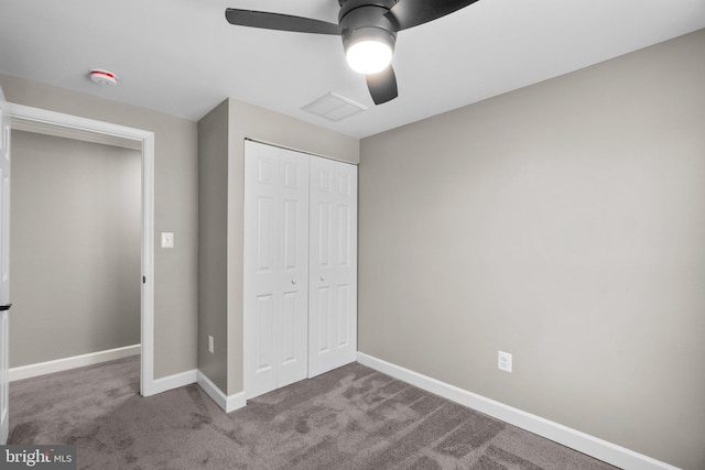 unfurnished bedroom featuring a closet, ceiling fan, baseboards, and carpet floors