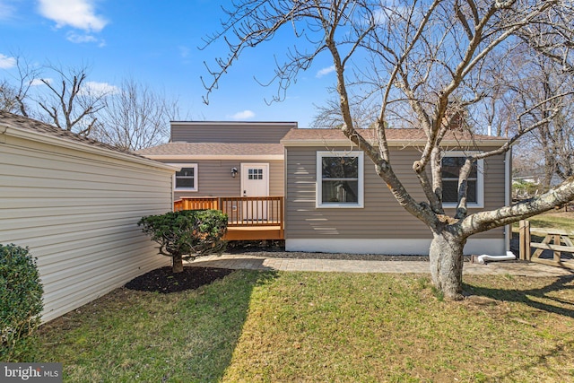 exterior space featuring a deck and a lawn