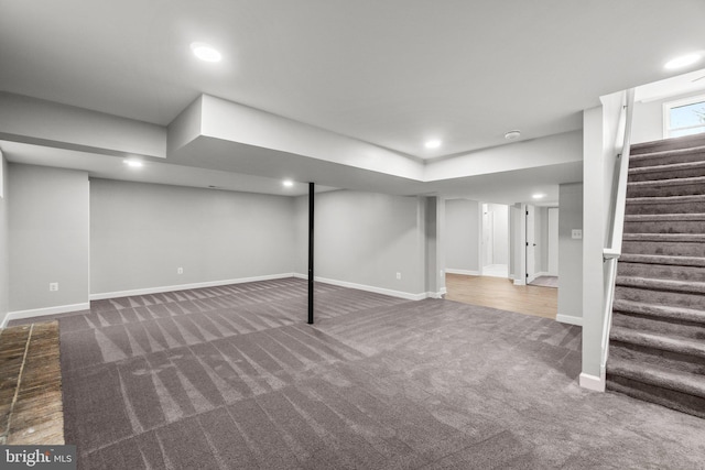 finished below grade area featuring recessed lighting, stairs, baseboards, and carpet floors