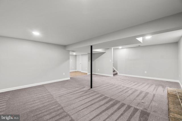 finished below grade area featuring carpet flooring, recessed lighting, stairs, and baseboards