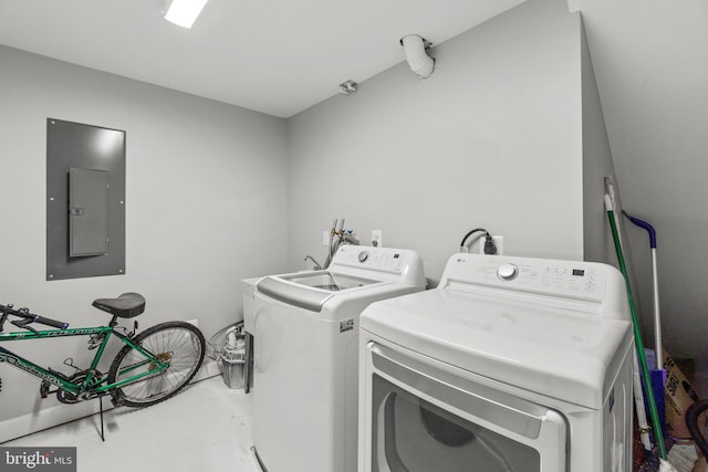 washroom featuring electric panel, laundry area, and washer and dryer