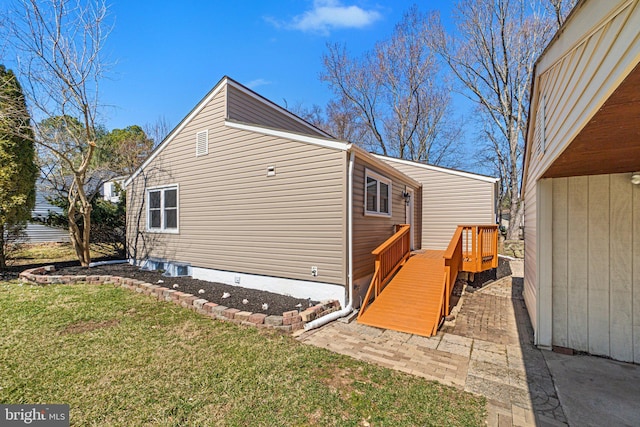 view of side of home featuring a yard