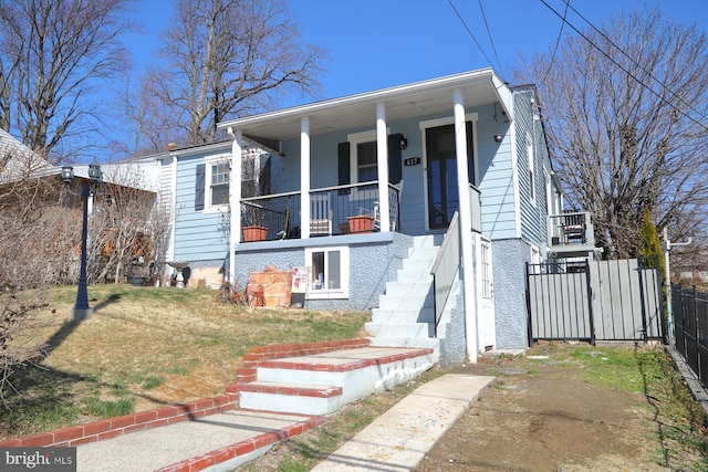 view of front of home with covered porch and fence