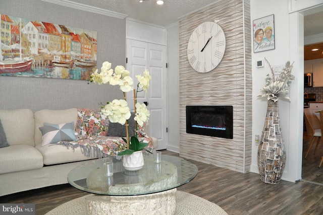 living room with wood finished floors, crown molding, recessed lighting, and a fireplace