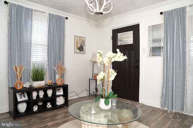 foyer featuring an inviting chandelier, crown molding, wood finished floors, and a textured ceiling