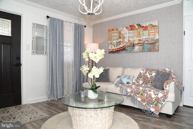 living room featuring a textured ceiling, wood finished floors, a chandelier, and ornamental molding