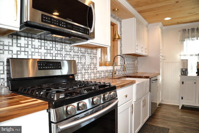 kitchen with wooden ceiling, white cabinets, appliances with stainless steel finishes, and butcher block counters