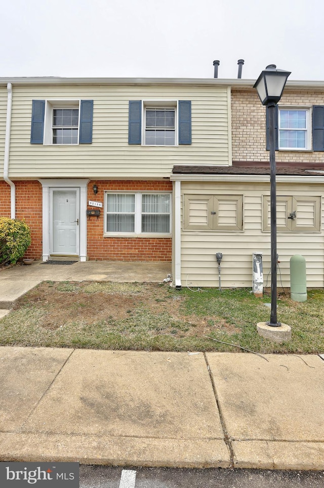 view of property featuring brick siding