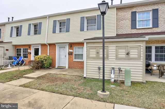 townhome / multi-family property featuring brick siding