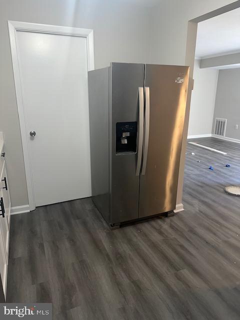 kitchen featuring visible vents, white cabinetry, stainless steel refrigerator with ice dispenser, and dark wood-style flooring