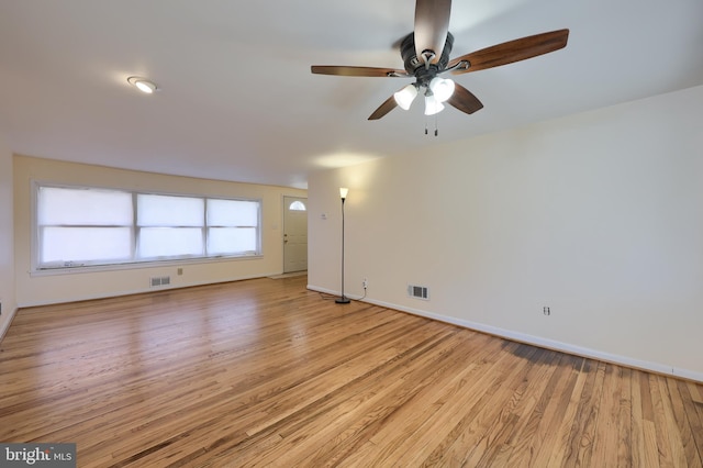 spare room featuring visible vents, baseboards, a ceiling fan, and light wood finished floors