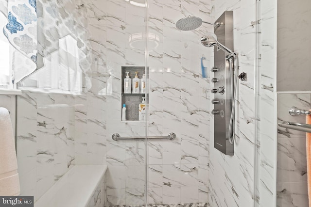 bathroom with a marble finish shower