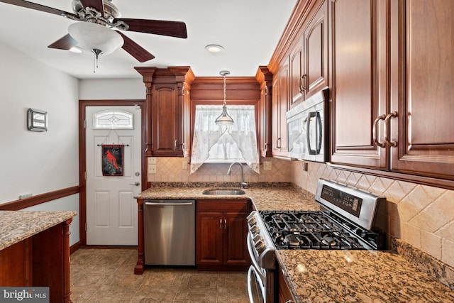 kitchen featuring a sink, backsplash, appliances with stainless steel finishes, and a healthy amount of sunlight