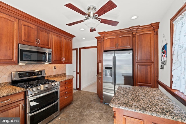 kitchen featuring backsplash, ceiling fan, light stone countertops, recessed lighting, and appliances with stainless steel finishes