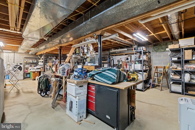 unfinished basement featuring a workshop area