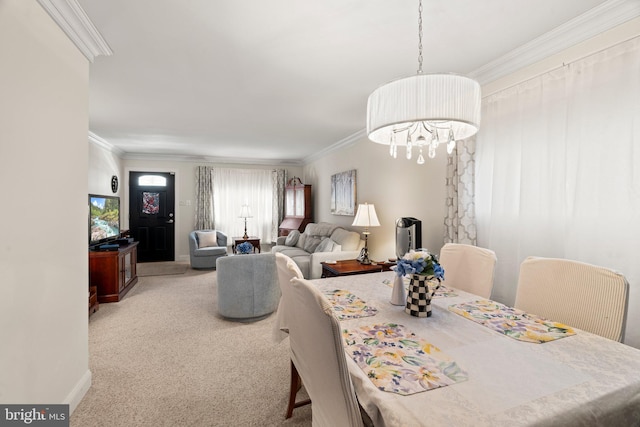 carpeted dining area with crown molding, baseboards, and a chandelier