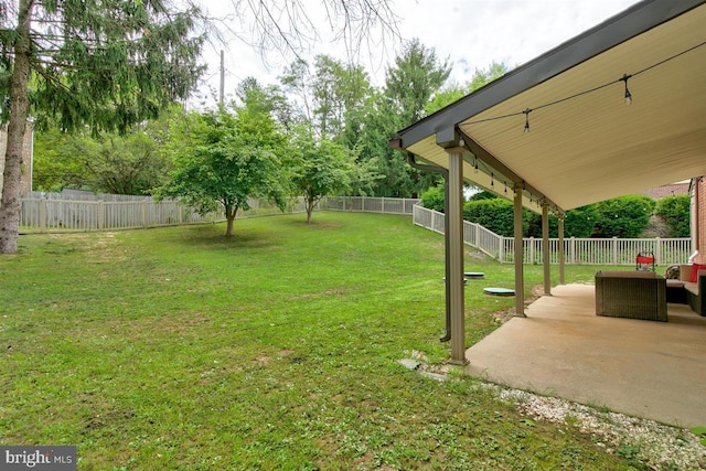 view of yard with a fenced backyard, an outdoor living space, and a patio