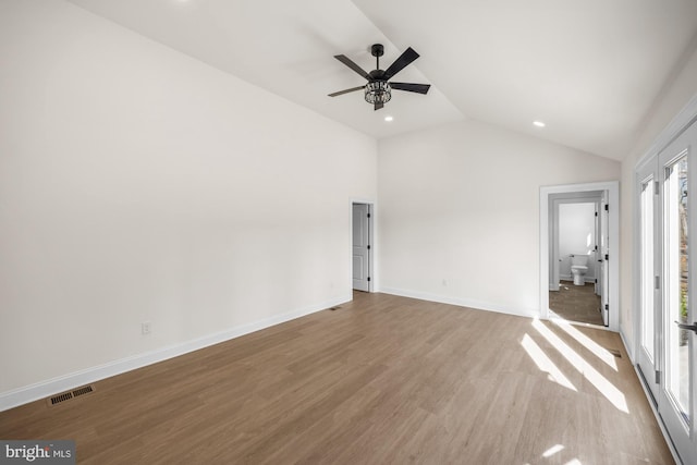 unfurnished bedroom featuring visible vents, wood finished floors, baseboards, lofted ceiling, and ceiling fan