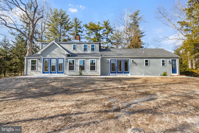 rear view of property with a chimney