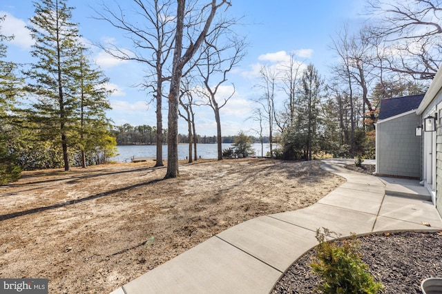 view of yard featuring a patio and a water view