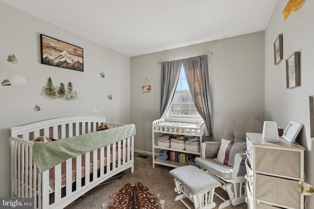 carpeted bedroom featuring visible vents, baseboards, and a nursery area