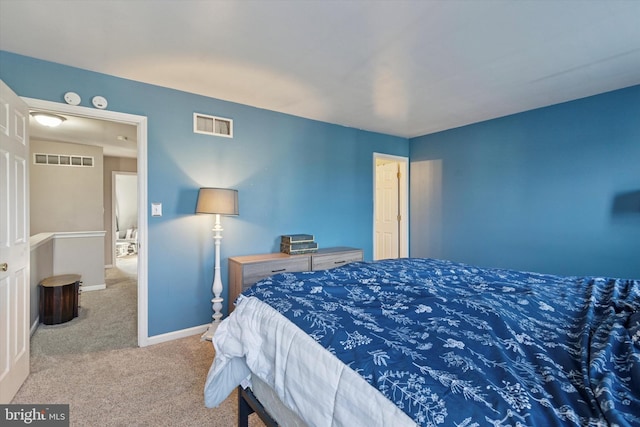 bedroom featuring visible vents, baseboards, and carpet