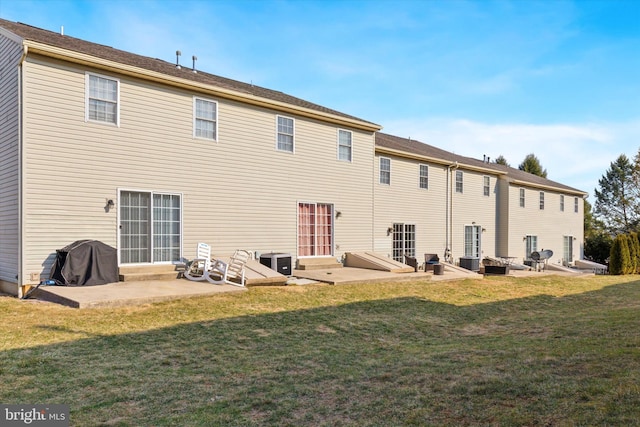 back of property with a lawn, entry steps, central AC, and a patio