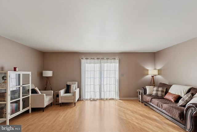 living area with wood finished floors and baseboards