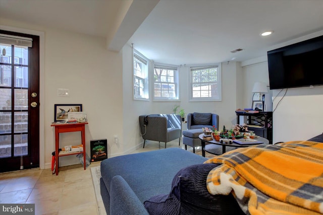 living room with baseboards, visible vents, and recessed lighting