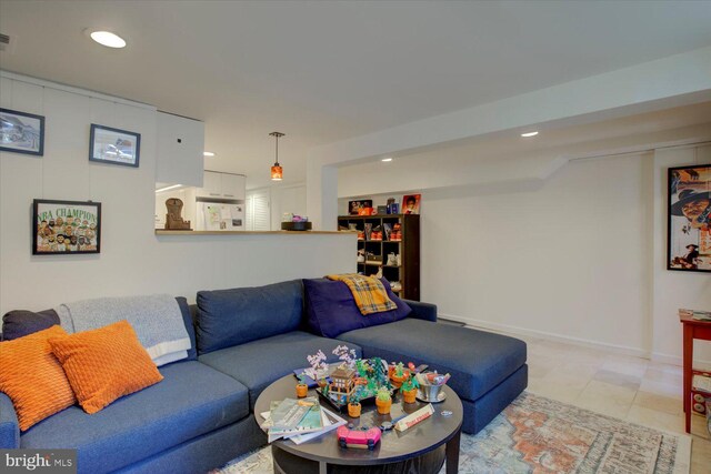 living room featuring baseboards and recessed lighting