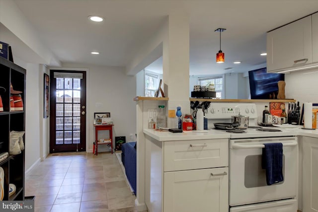 kitchen featuring white cabinetry, a healthy amount of sunlight, recessed lighting, and white electric range