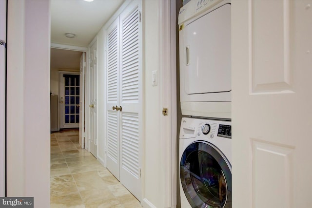 laundry room featuring stacked washer and dryer and laundry area