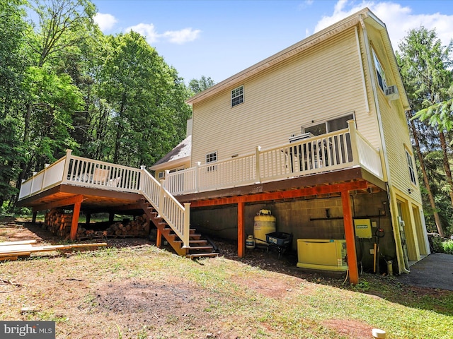 back of property featuring stairway and a deck