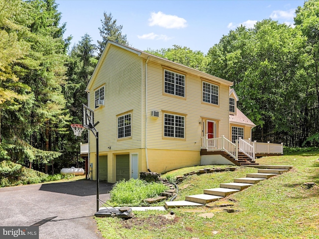 view of front of property with aphalt driveway and a garage