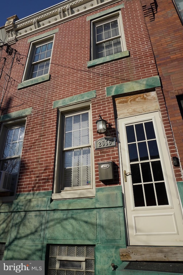 property entrance with brick siding